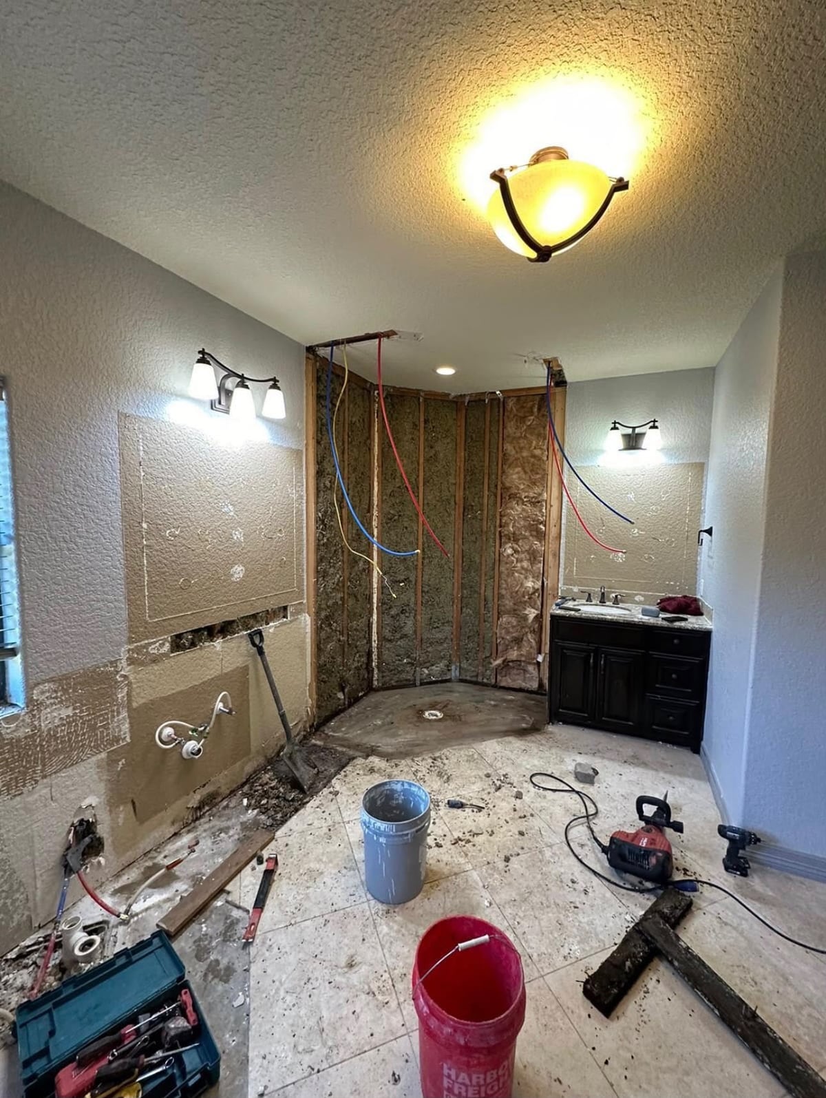 Houston bathroom during demolition with shower walls opened to framing