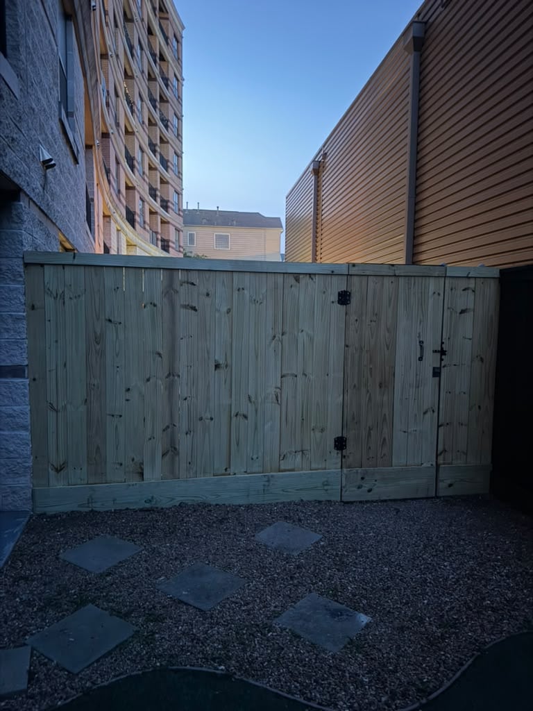 Completed double wood privacy gate across a side yard