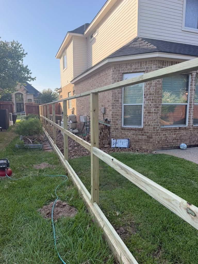 Wood privacy fence posts and horizontal rails during installation