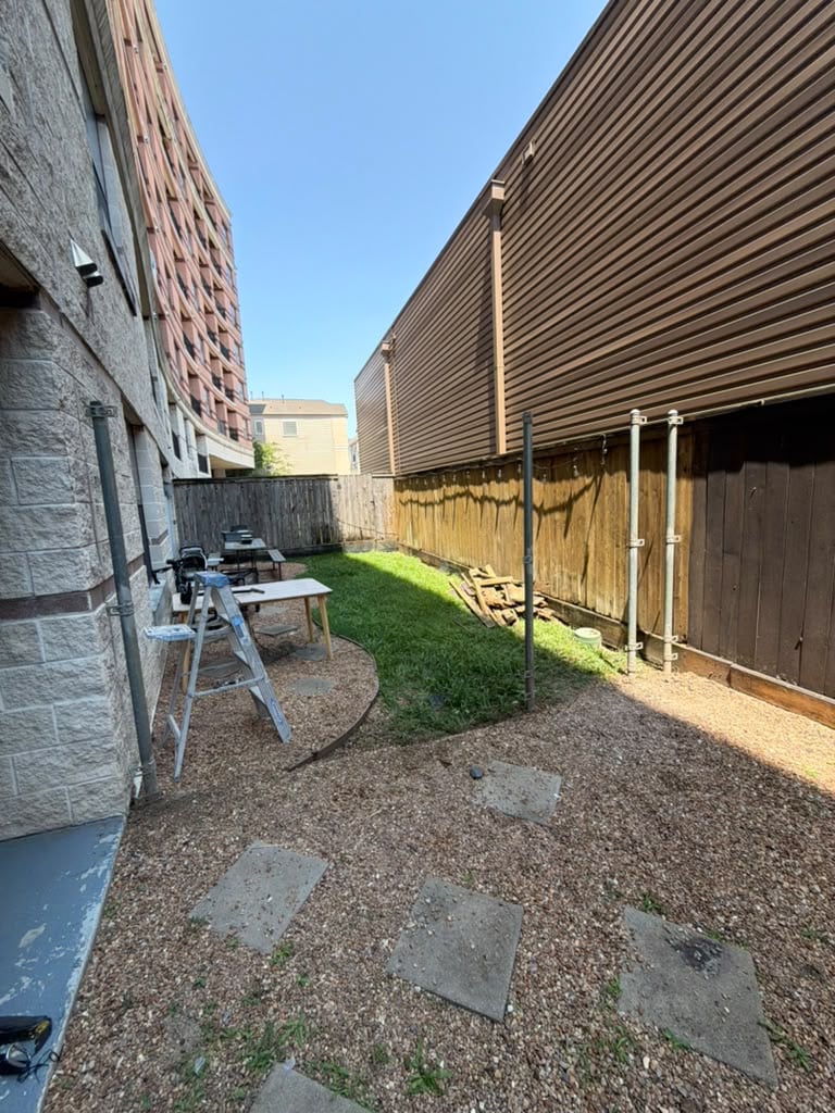 Side yard before installation of a new wood privacy fence